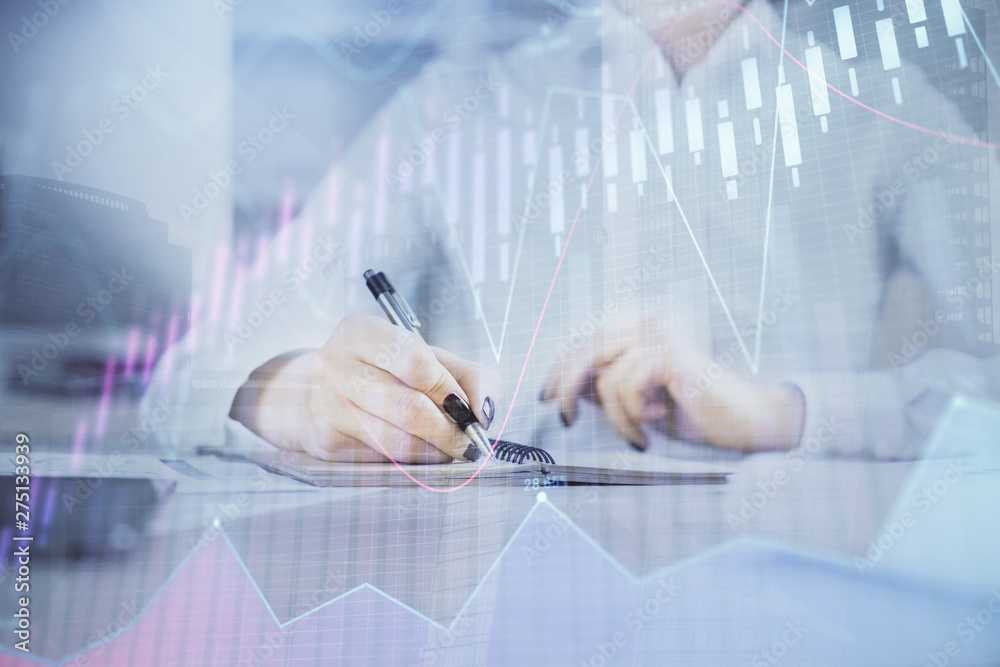 Financial chart drawn over hands taking notes background. Concept of research. Multi exposure Financial chart drawn over hands taking notes background. Concept of research. Multi exposure