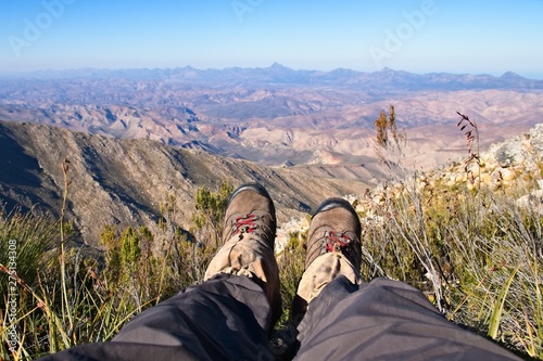 A mountaineer enjoying the view from Saptoukop peak in the Kouga mountains, South Africa. Hiking background picture. 