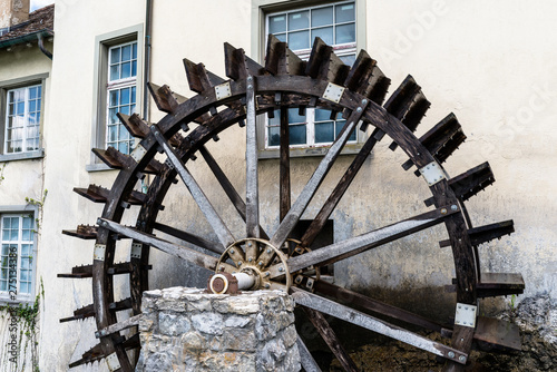Working a wooden, water wheel  for converting the energy of flowing water, at the beginning of the Rhine river in Switzerland.