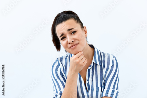Obraz na plátně Skeptic and mistrust emotion  portrait of Brunette girl against white background