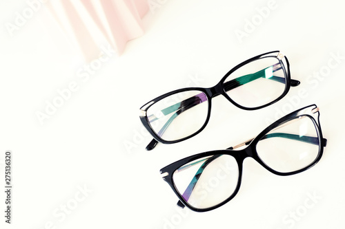 Flat lay stylish glasses on white background, optics store, medetsina ophthalmology concept. Eye health care concept.
