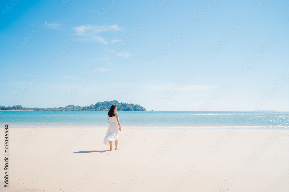 Beautiful young Asian woman happy relax walking on beach near sea. Lifestyle women travel on beach concept. Beautiful young Asian woman happy relax walking on beach near sea. Lifestyle women travel on beach concept.