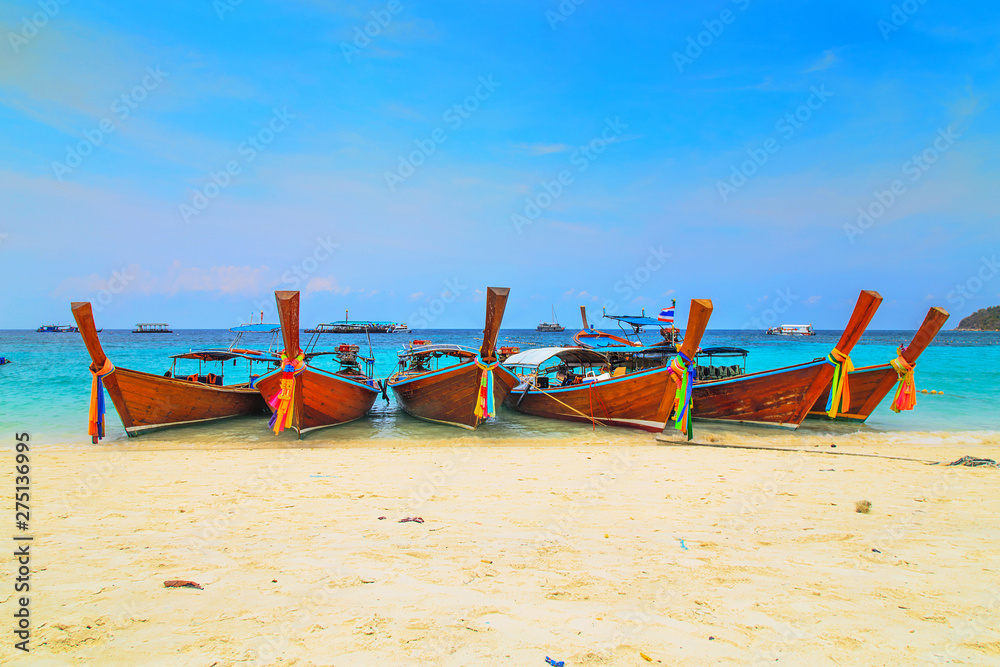 Long tailed boat at kho lipe satun Thailand/Fishing boat on the sea and blue sky background at kho lipe satun Thailand/Tropical beach kho lipe satun Thailand wooden long tailed boat on the sea/ Long tailed boat at kho lipe satun Thailand/Fishing boat on the sea and blue sky background at kho lipe satun Thailand/Tropical beach kho lipe satun Thailand wooden long tailed boat on the sea/