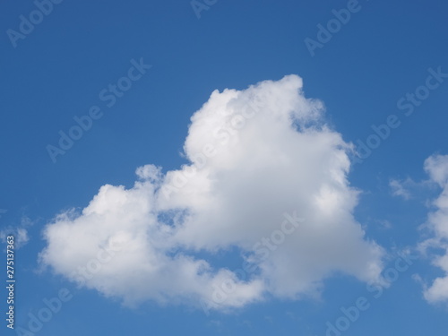 Cloudy sky background, view of fat white clouds moving in blue sky background.