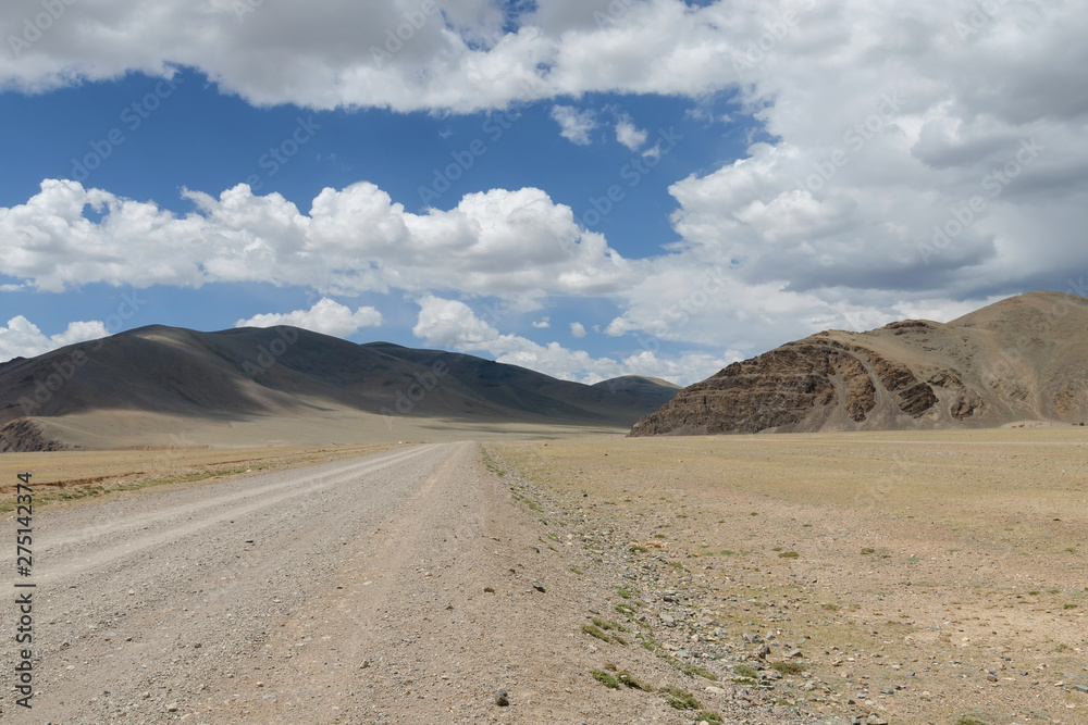 Western Mongolia steppe landscape. Dirt road between Russian border and Tsagaannuur town. Bayan-Ulgii Province, Mongolia.