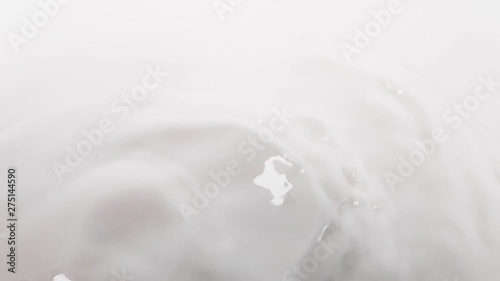 the texture of the surface of the milk, poured into a bowl. slow motion