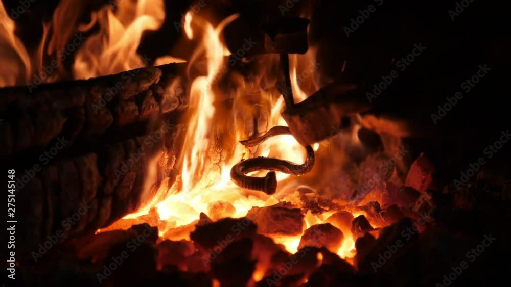 Sparkling furnace flame with high forks in an old Ukrainian smithy workshop Sparkling furnace flame with high forks in an old Ukrainian smithy workshop