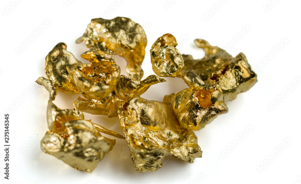 A few gold nuggets isolated on white background. Selective focus. A few gold nuggets isolated on white background. Selective focus.
