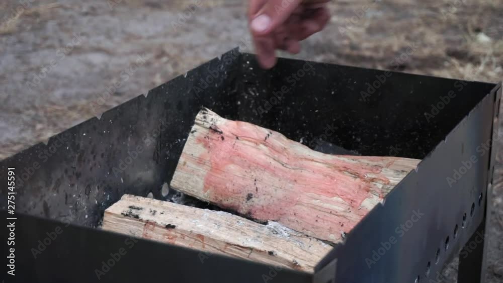 Soaking wood logs in the grill before BBQ Soaking wood logs in the grill before BBQ