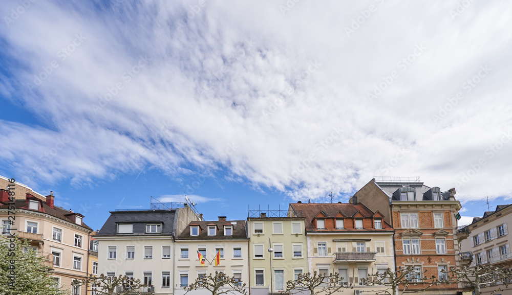 Beautiful exterior of the upper floors and roofs of residential buildings against the sky in Europe, Germany. Roofs of German houses against the sky, template for text