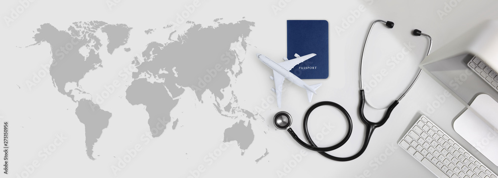 international medical travel insurance concept, stethoscope, passport, computer and airplane on desk office banner with global map - obrazy, fototapety, plakaty 