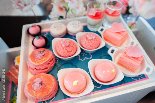 Sweet pastel peach and pink colorful set of afternoon tea in Sakura or Cherry Blossom theme. Tasty and delicious dessert, chocolate, bakery and pastry. Good for high tea party or Birthday celebration.