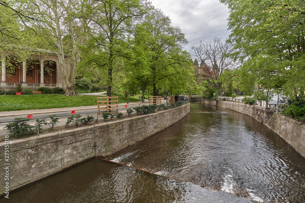 Beautiful river Ooc along the city of Baden-Baden, in spring. Well-groomed and clean city river and trees in a European city Beautiful river Ooc along the city of Baden-Baden, in spring. Well-groomed and clean city river and trees in a European city