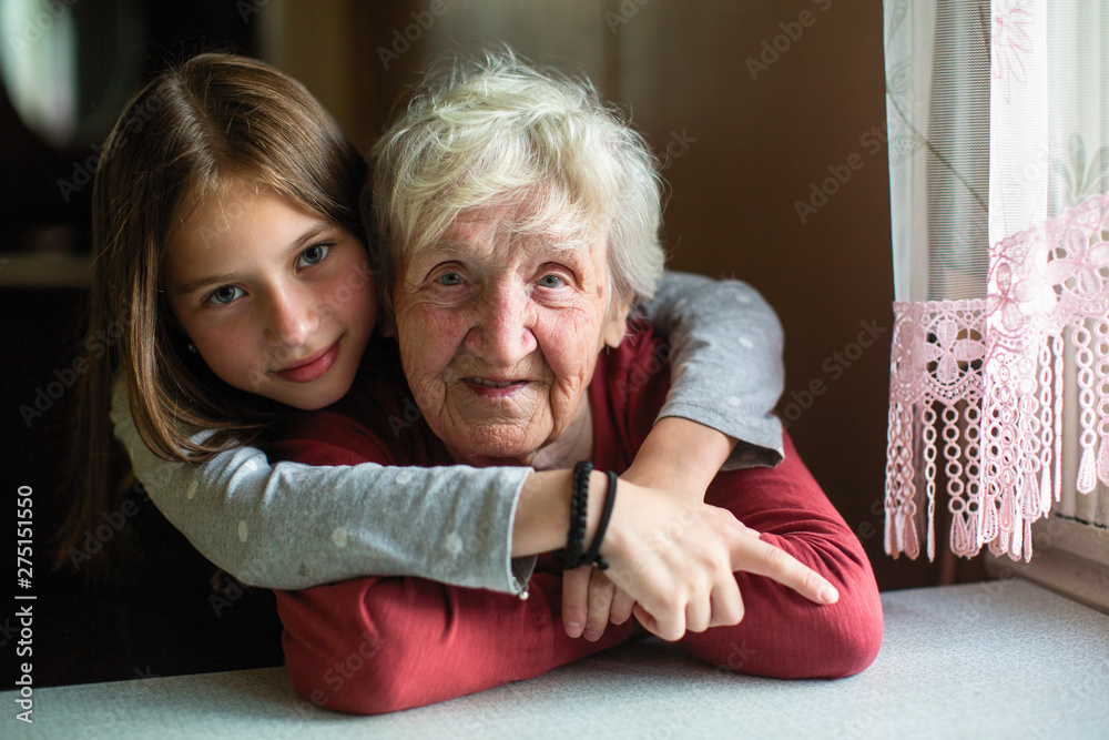 Portraits of the little girl and her old grandmother. - obrazy, fototapety, plakaty 