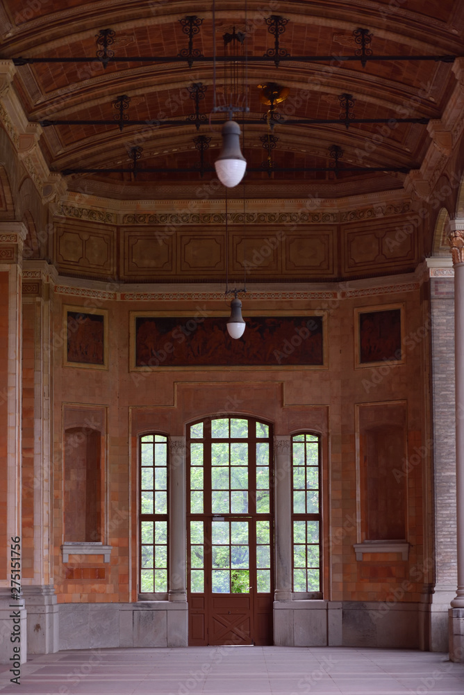 Beautiful and old large full-wall glass window with a door and access to the garden. European architecture Beautiful and old large full-wall glass window with a door and access to the garden. European architecture