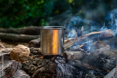 steel cup on an open fire in nature.