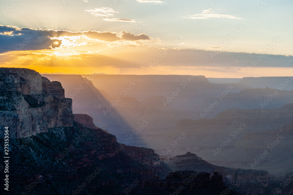 The setting sun sinking below the horizon of the Grand Canyon, near Yavapai point on the southern canyon rim.