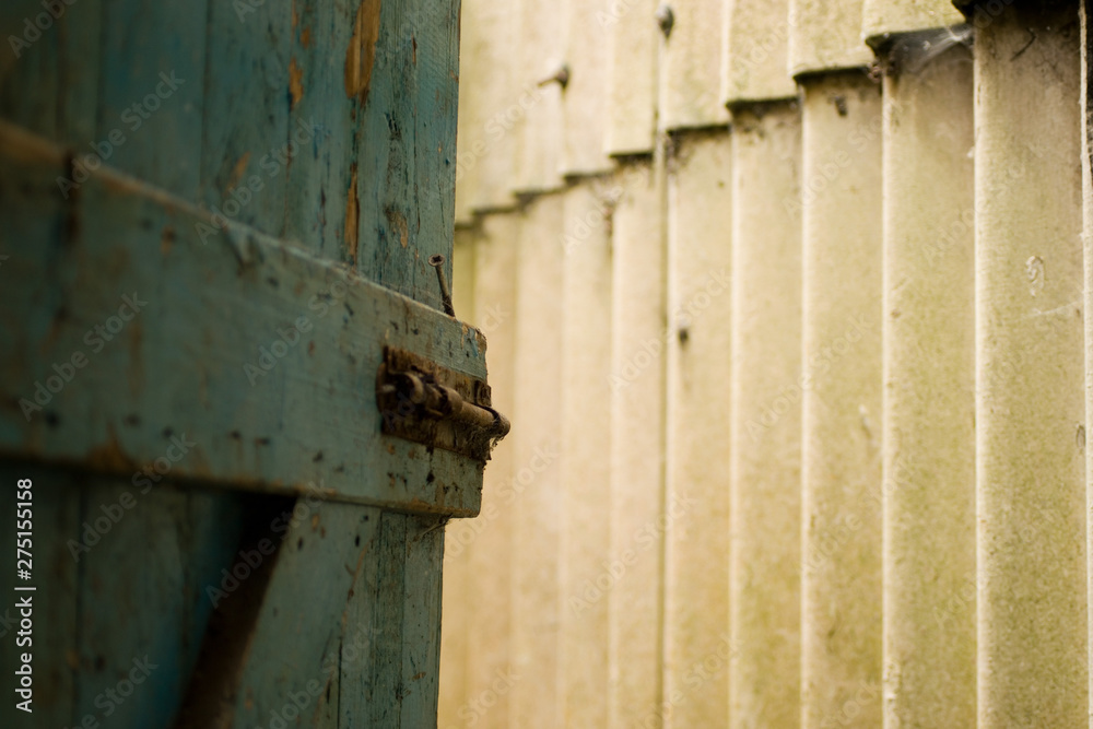 An old wooden blue door to the outside An old wooden blue door to the outside