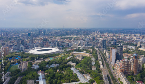 stadium in a green city, a terrible sky and the sun's rays. Kyiv, Ukraine  - Cityscape Aerial Flight photo