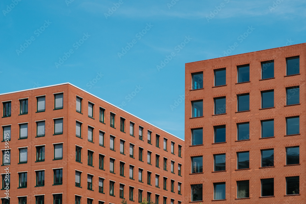  red brick building blocks and blue sky - real estate  concept