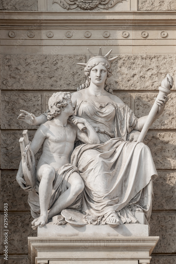 Old symbolic statue of Europa, a powerful woman with torch and young boy with musical instrument and  easel for painting located in museums district, downtown in Vienna, Austria