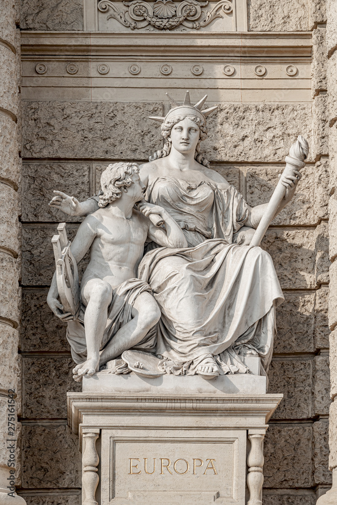 Old symbolic statue of Europa, a powerful woman with torch and young boy with musical instrument and  easel for painting located in museums district, downtown in Vienna, Austria
