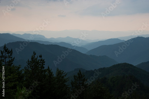 Panoramic landscape silhouettes of blue mountains with mist after rain in Rhodopi range photo