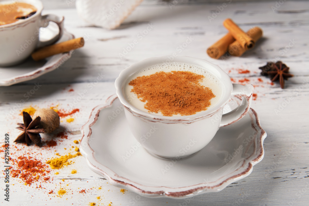 Traditional indian hot drink masala tea with spices on wooden background with ingredients Traditional indian hot drink masala tea with spices on wooden background with ingredients
