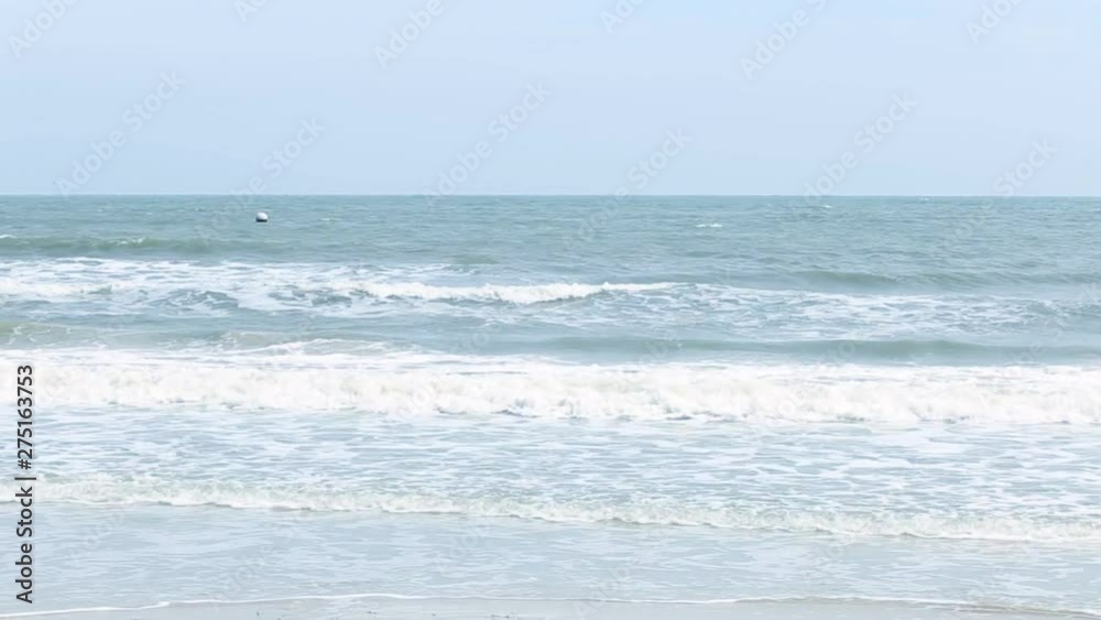 Narrow beach line,Sea waves with wave crashing on sandy shore Narrow beach line,Sea waves with wave crashing on sandy shore