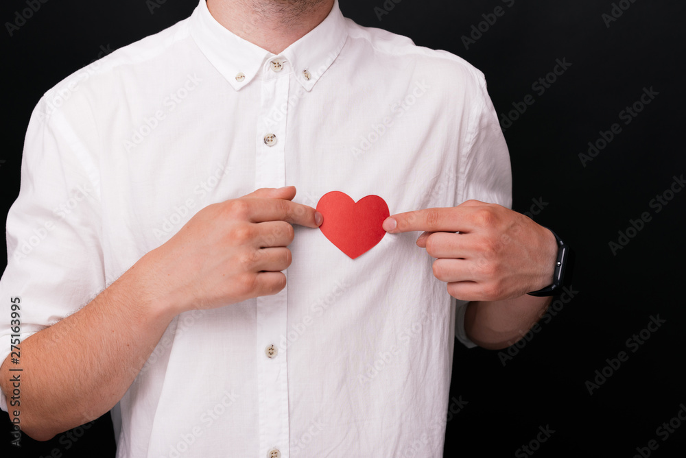 Man`s hands holding a red paper heart Man`s hands holding a red paper heart