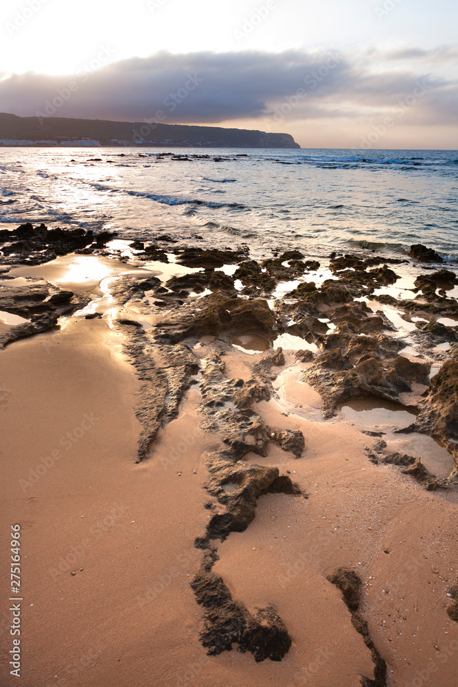 BEACH LANDSCAPE WITH ROCKS AND DAWN AT THE TRAFALGAR BEACH IN CADIZ IN SPAIN