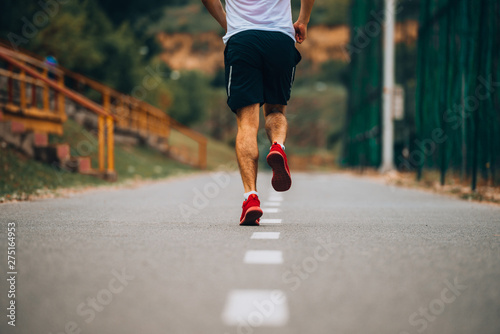 Young fitness man running in urban area