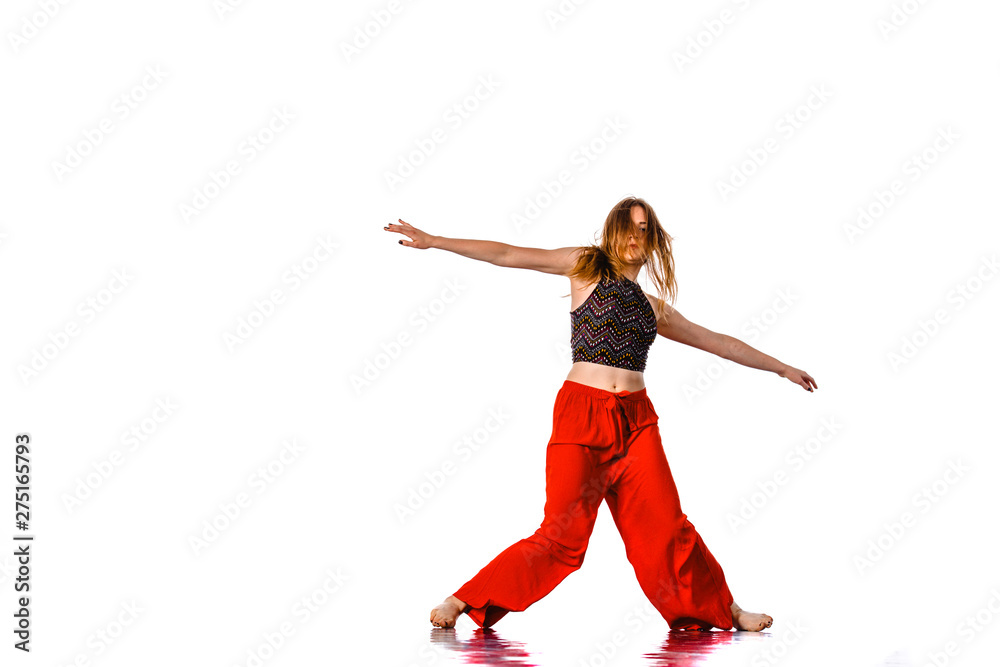 Modern active female artist dancing excited posing in studio. Sport, gym and fitness