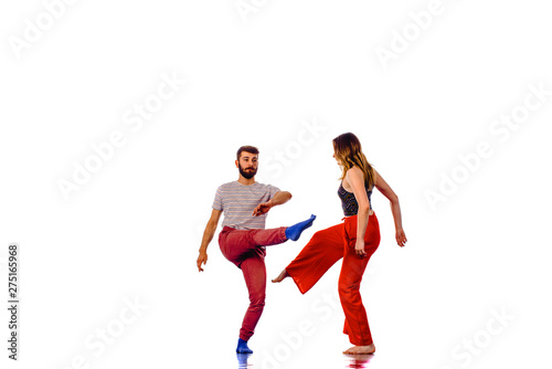 Beautiful couple of ballet dancers dancing over white background