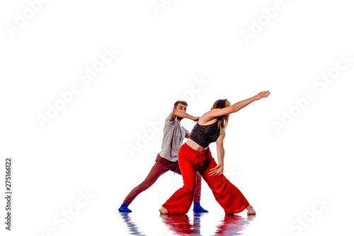 Two young breakdancers dancing together, isolated on white
