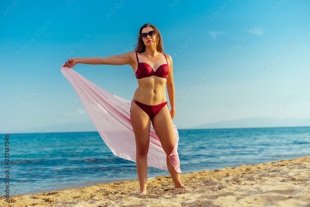 Carefree, Young woman relaxing on the sand beach Carefree, Young woman relaxing on the sand beach