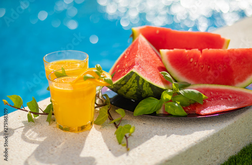 Wallpaper Mural Summer holiday tropical concept. Fresh orange juice and watermelon juice and pineapple on border of a swimming pool. Torontodigital.ca