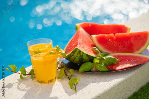 Wallpaper Mural Summer holiday tropical concept. Fresh orange juice and watermelon juice and pineapple on border of a swimming pool. Torontodigital.ca