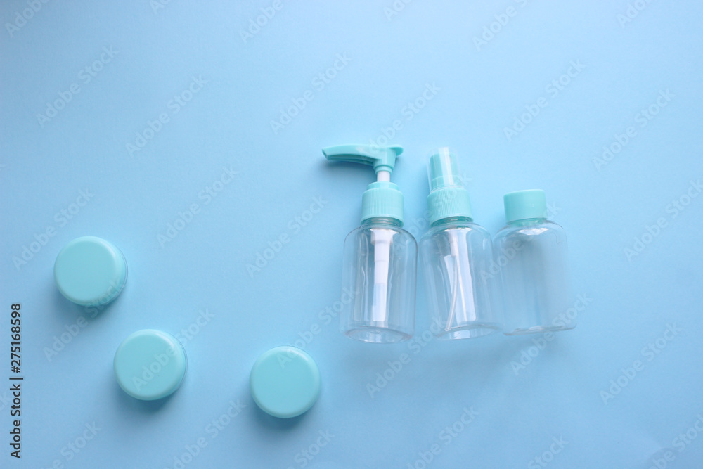 Set of plastic bottles to carry liquids in your Luggage. A micro-bottle for travel. Bottles with different lids. The view from the top. Blue background. Set of plastic bottles to carry liquids in your Luggage. A micro-bottle for travel. Bottles with different lids. The view from the top. Blue background.