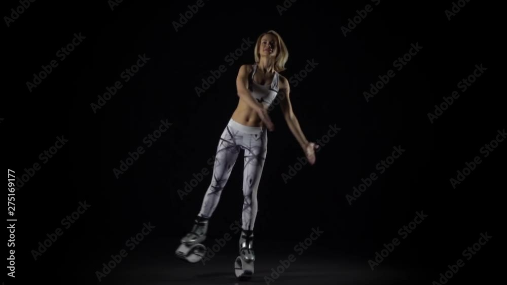 Slow motion, sportswoman performing exercises in kangoo jumps shoes. Slow motion, sportswoman performing exercises in kangoo jumps shoes.