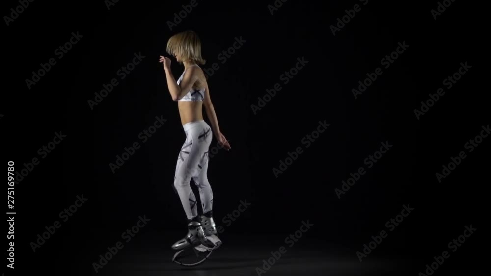 Fitness instructor performing exercises in kangoo jumps shoes. Slow motion Fitness instructor performing exercises in kangoo jumps shoes. Slow motion