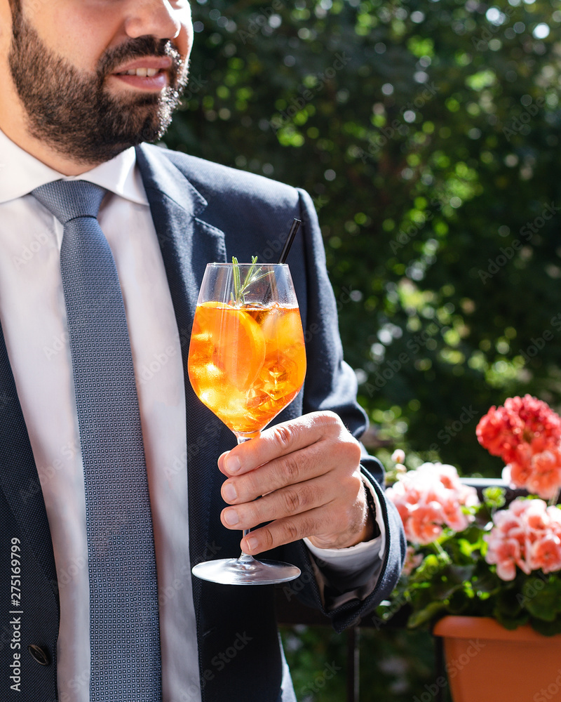 Fototapeta premium Man holding glass with italian aperol spritz