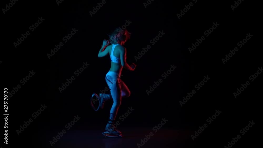Pretty trainer doing exercises in kangoo jumps shoes. Slow motion Pretty trainer doing exercises in kangoo jumps shoes. Slow motion