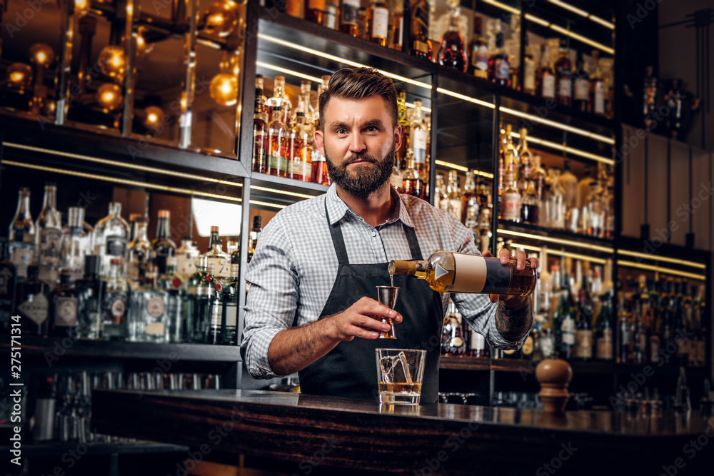 Cheerful barman is making beverage for customers at cozy restauraunt. Cheerful barman is making beverage for customers at cozy restauraunt.