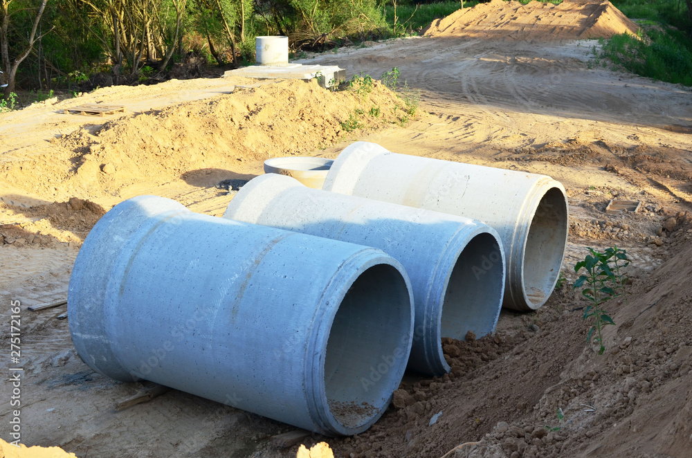 Laying or replacement of underground storm sewer pipes. Installation of water main, sanitary sewer, storm drain systems in city. Concrete drainage pipe. Utility Infrastructure - Image
