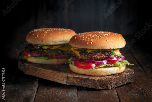 Homemade burgers on rustic wood background close up
