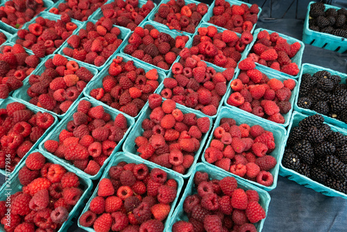 Diagonal blue cartons of raspberries and blackberries