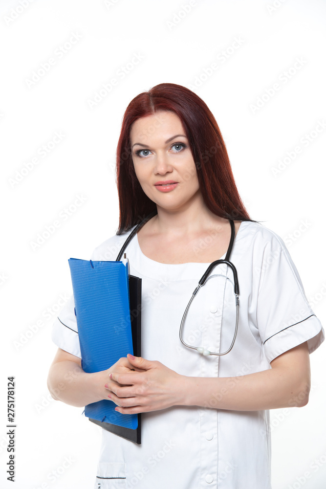 Happy young female family doctor holds blue folder with documents, has friendly expression, isolated white background. Medicine concept. Happy young female family doctor holds blue folder with documents, has friendly expression, isolated white background. Medicine concept.
