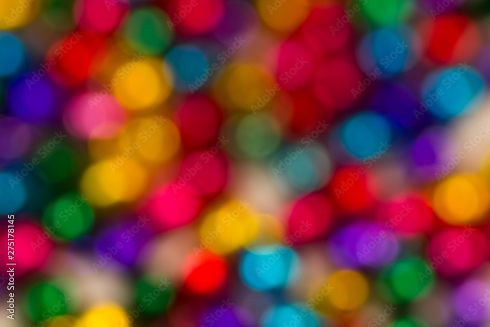 blurred bokeh bright multicolored iridescent glowing gold dimming beads spread on the table background