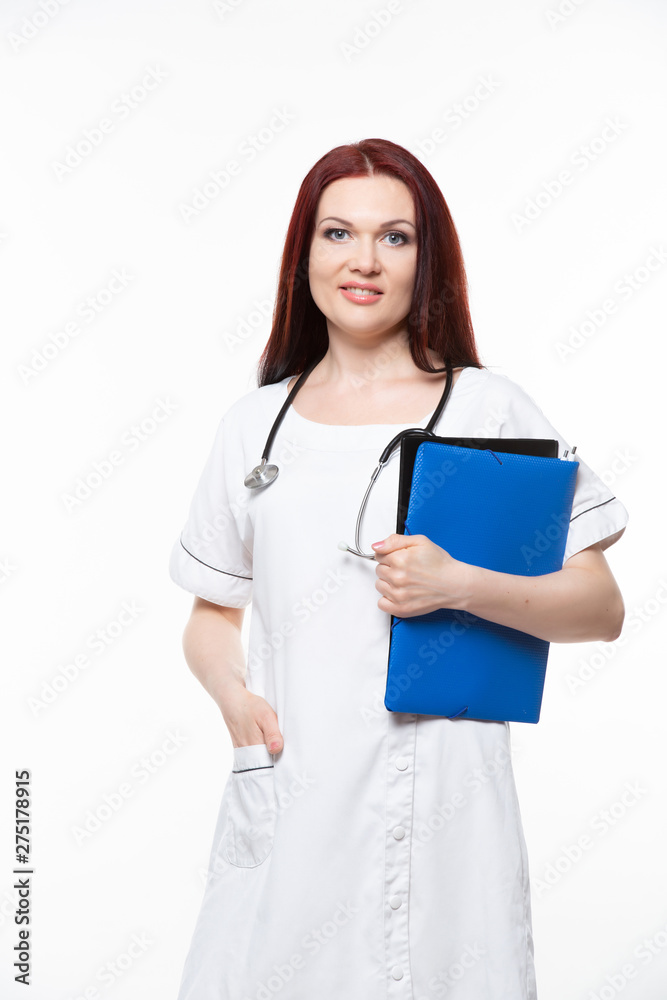 Happy young female family doctor holds blue folder with documents, has friendly expression, isolated white background. Medicine concept. Happy young female family doctor holds blue folder with documents, has friendly expression, isolated white background. Medicine concept.